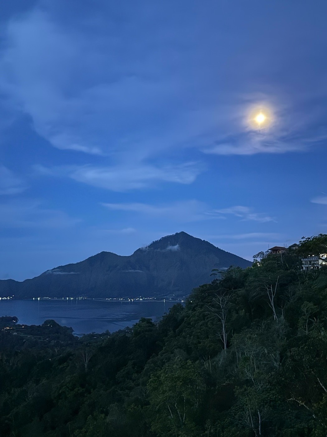 Full moon over Lake Batur. Mount Abang and the lake at night